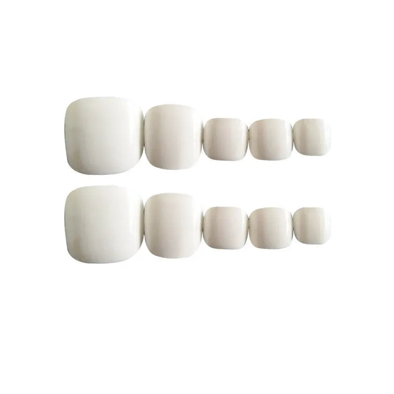 Set of white false nails with a starry sky pattern and glue adhesive for application.