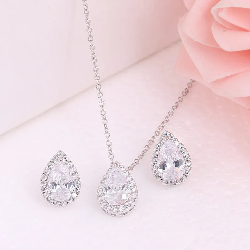 Women's water drop gemstone necklace and earrings set in copper with zircon on white background