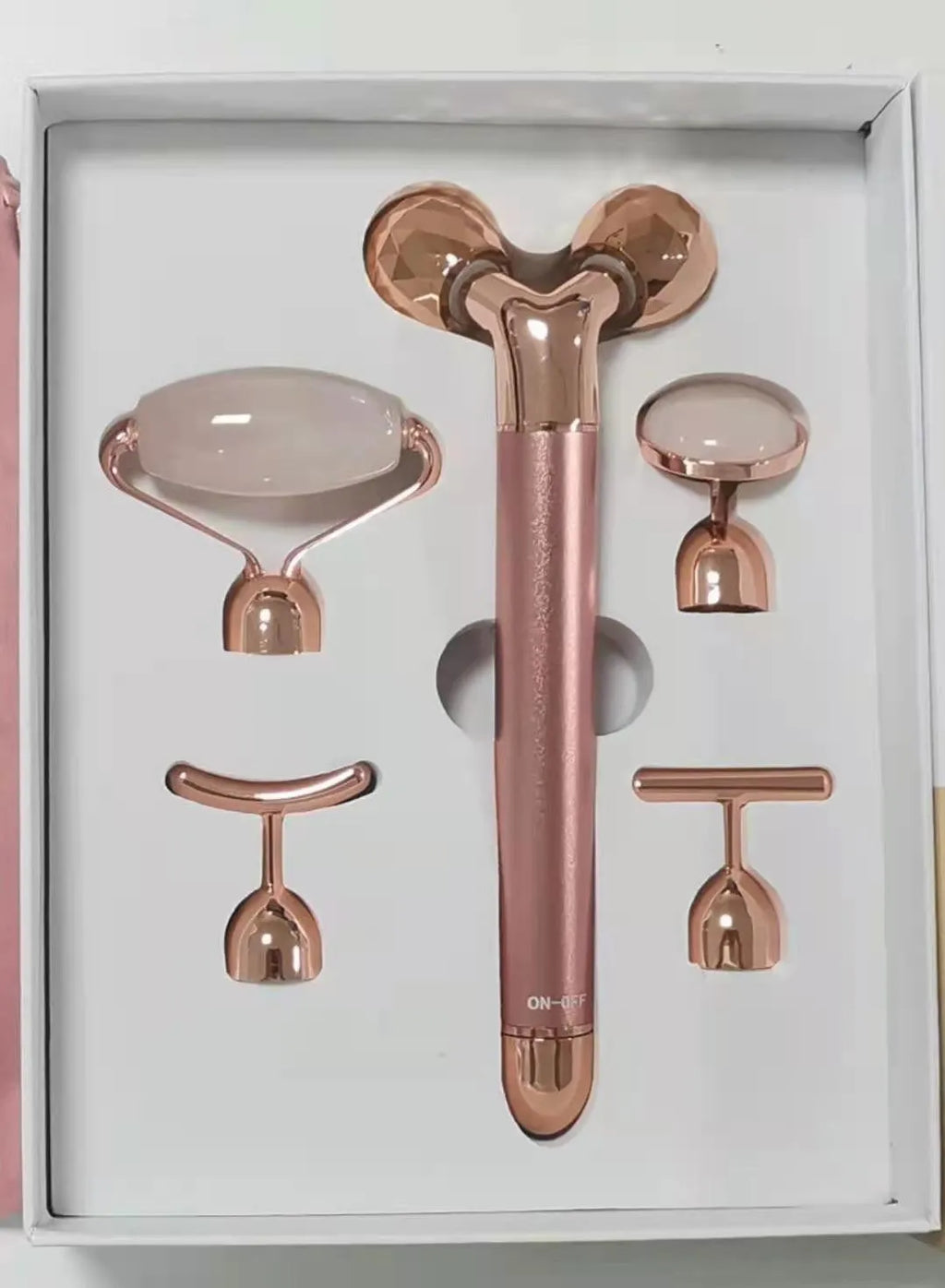 Rose gold five-in-one vibrating face massager with jade roller, disc, U-shaped and T-shaped beauty heads in colour box