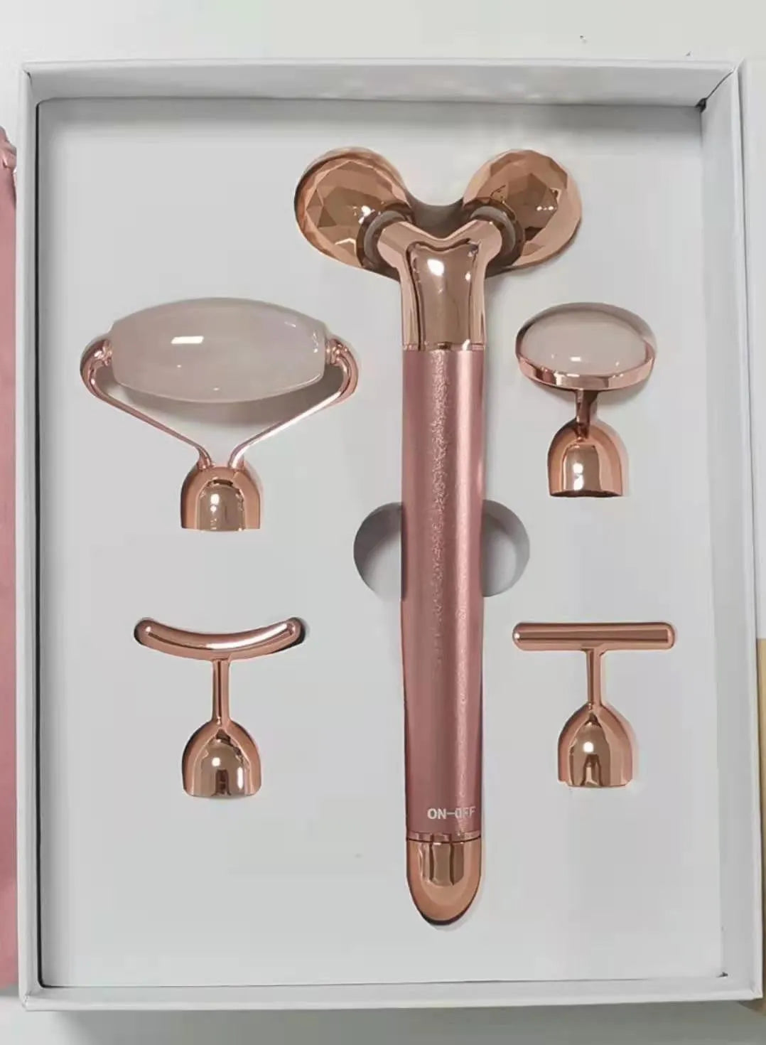 Rose gold five-in-one vibrating face massager with jade roller, disc, U-shaped and T-shaped beauty heads in colour box