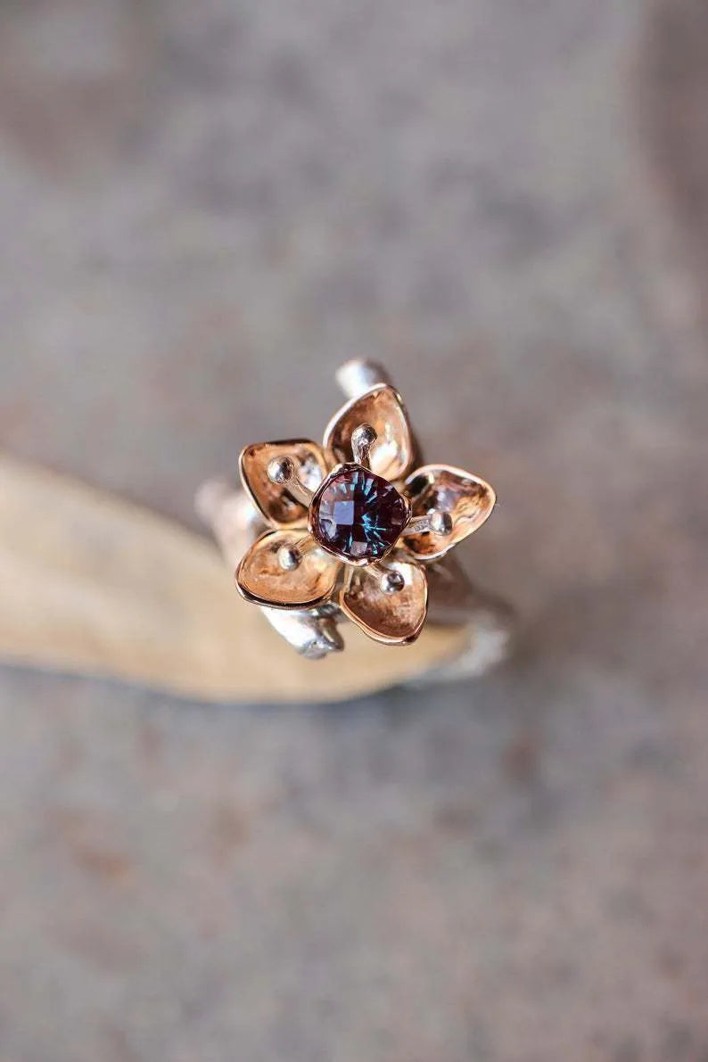 A two-tone silver women's ring with a geometric band and a floral ornament.