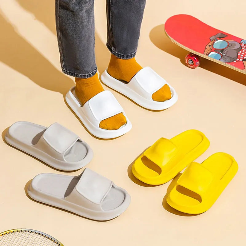 Pair of thick-soled EVA flip-flop slippers in a chosen colour on a bathroom floor.