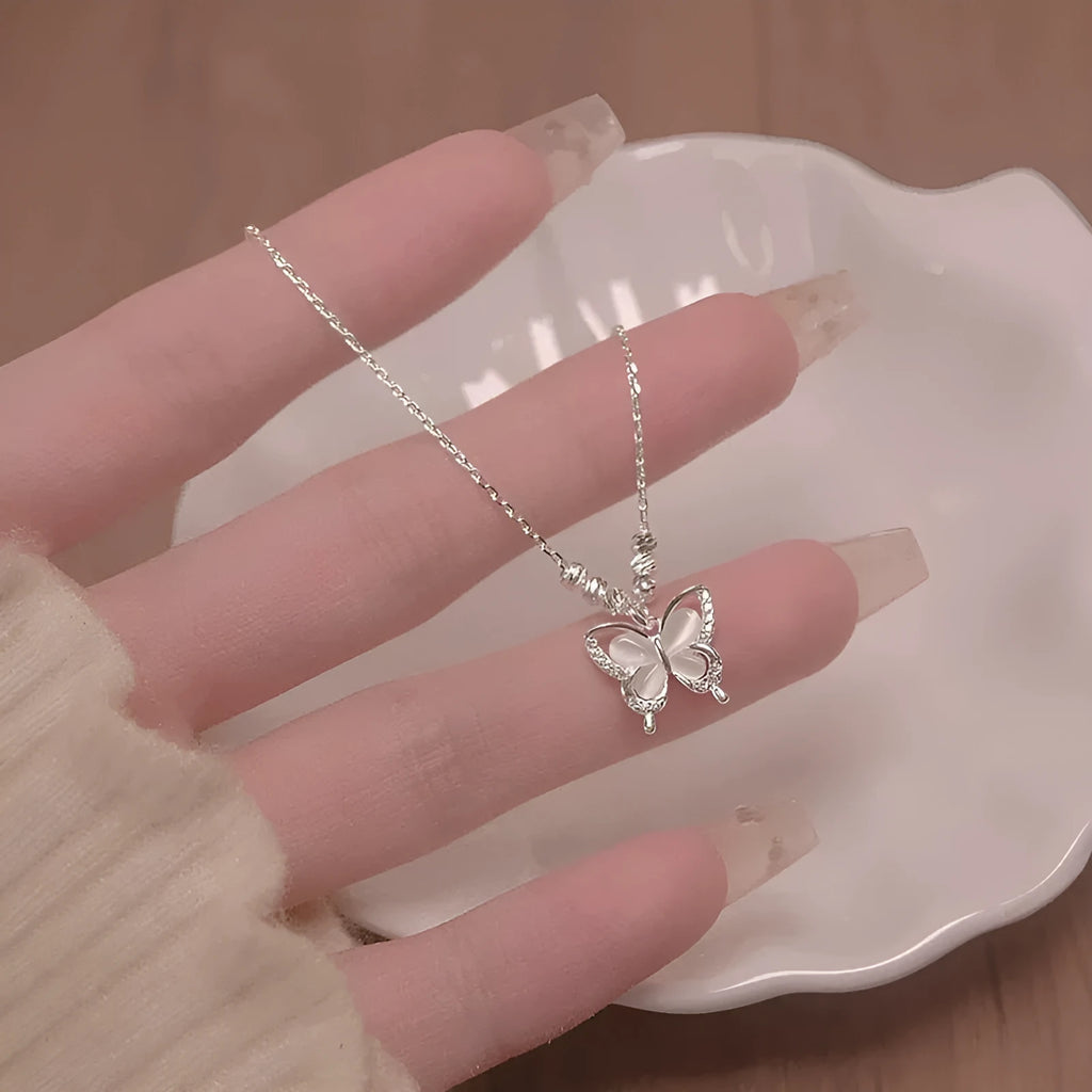 Silver necklace with square opal butterfly pendant on an adjustable cross chain.
