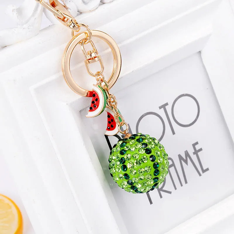 Green watermelon-shaped zinc alloy keychain with decorative accents, shown on a key ring.