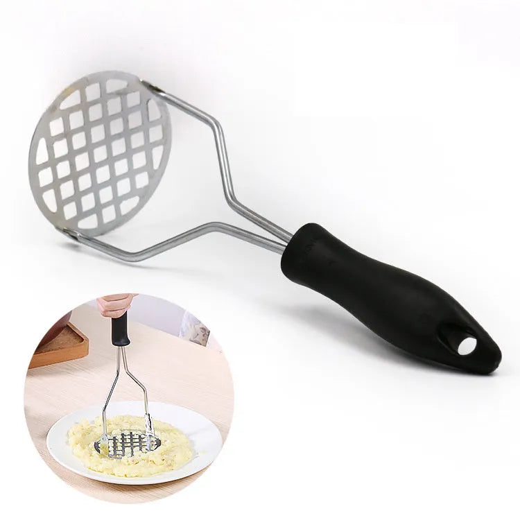 Manual potato masher with flower-shaped iron plated head and wooden handle on white background
