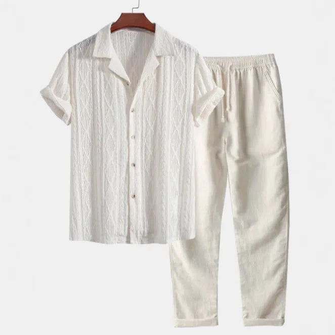 Casual linen suit set with camouflage print, featuring a short-sleeved top and matching trousers.