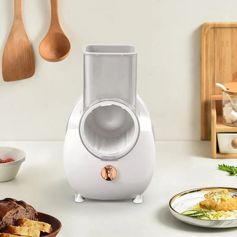 White electric vegetable slicer with suction base and multiple blades for kitchen food preparation