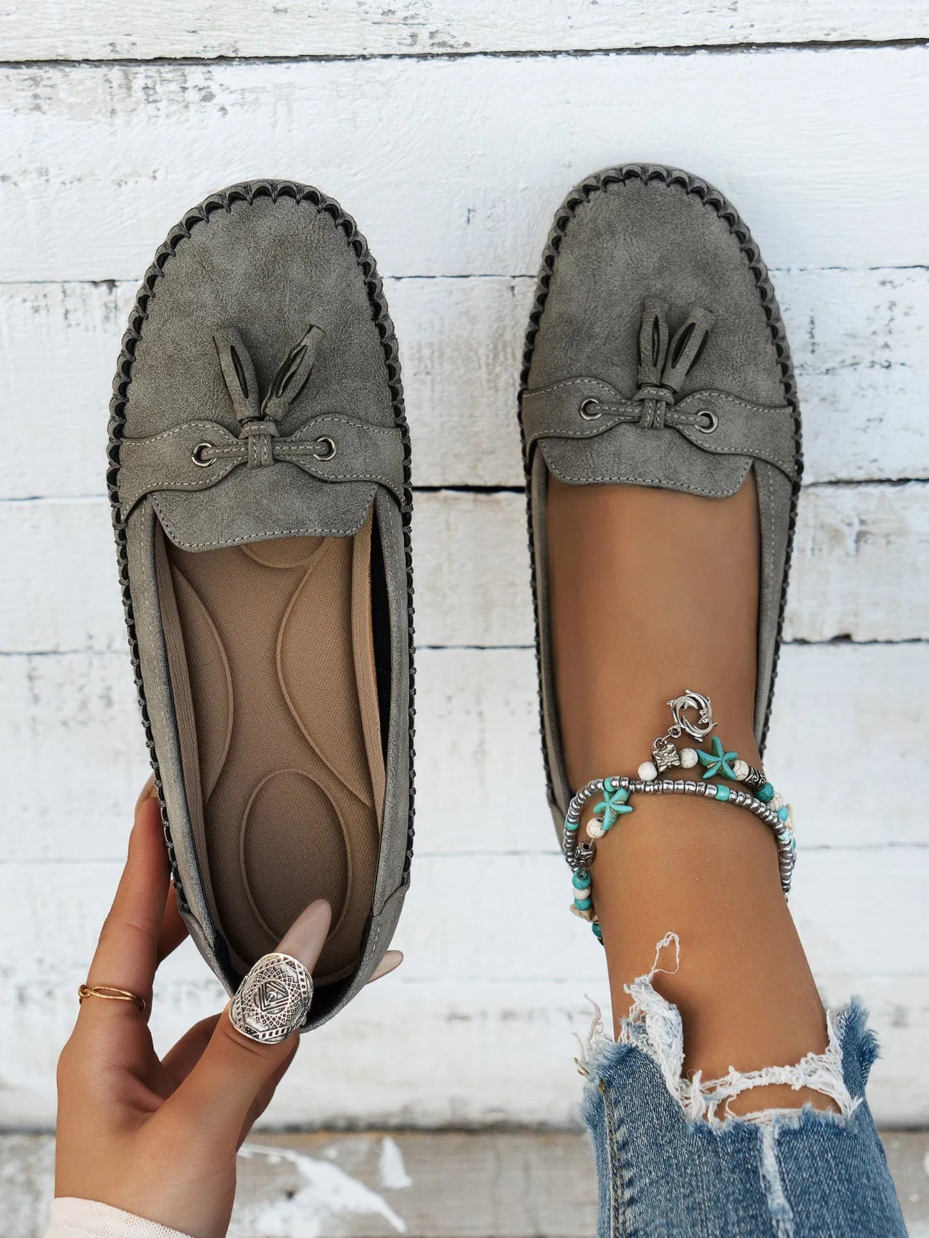 Women's suede flat shoes with a bow in pink, apricot, grey, or blue on a low polyurethane sole.