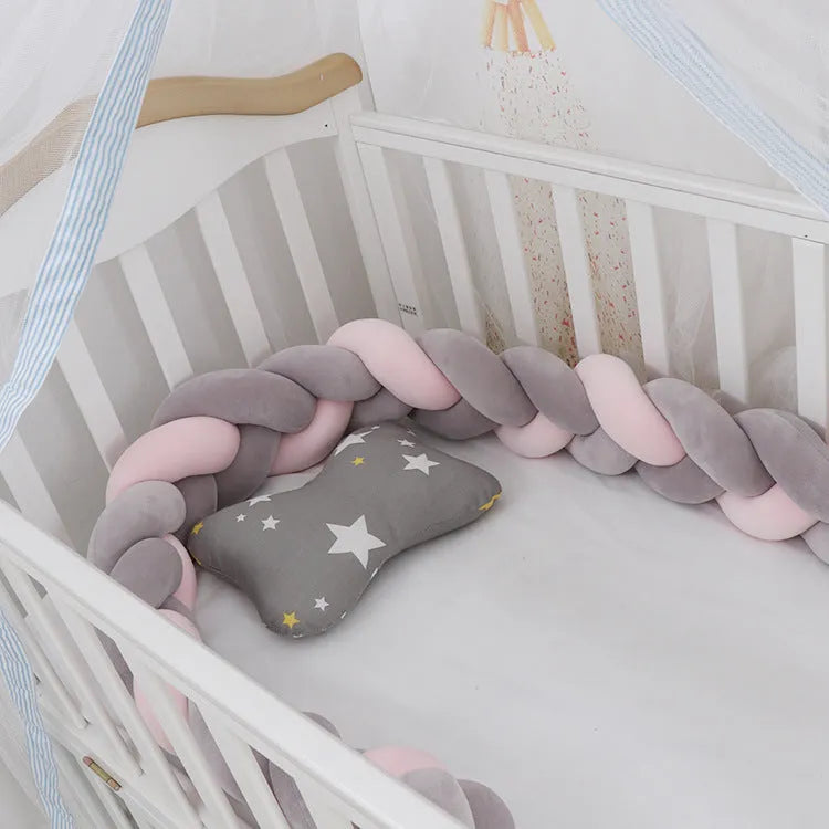 Spandex crystal velvet baby cot bumper in grey pink colour, shown flexible and long.