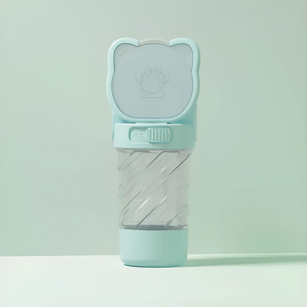 Green 3-in-1 portable pet water bottle with food container and bag dispenser, held by its strap.