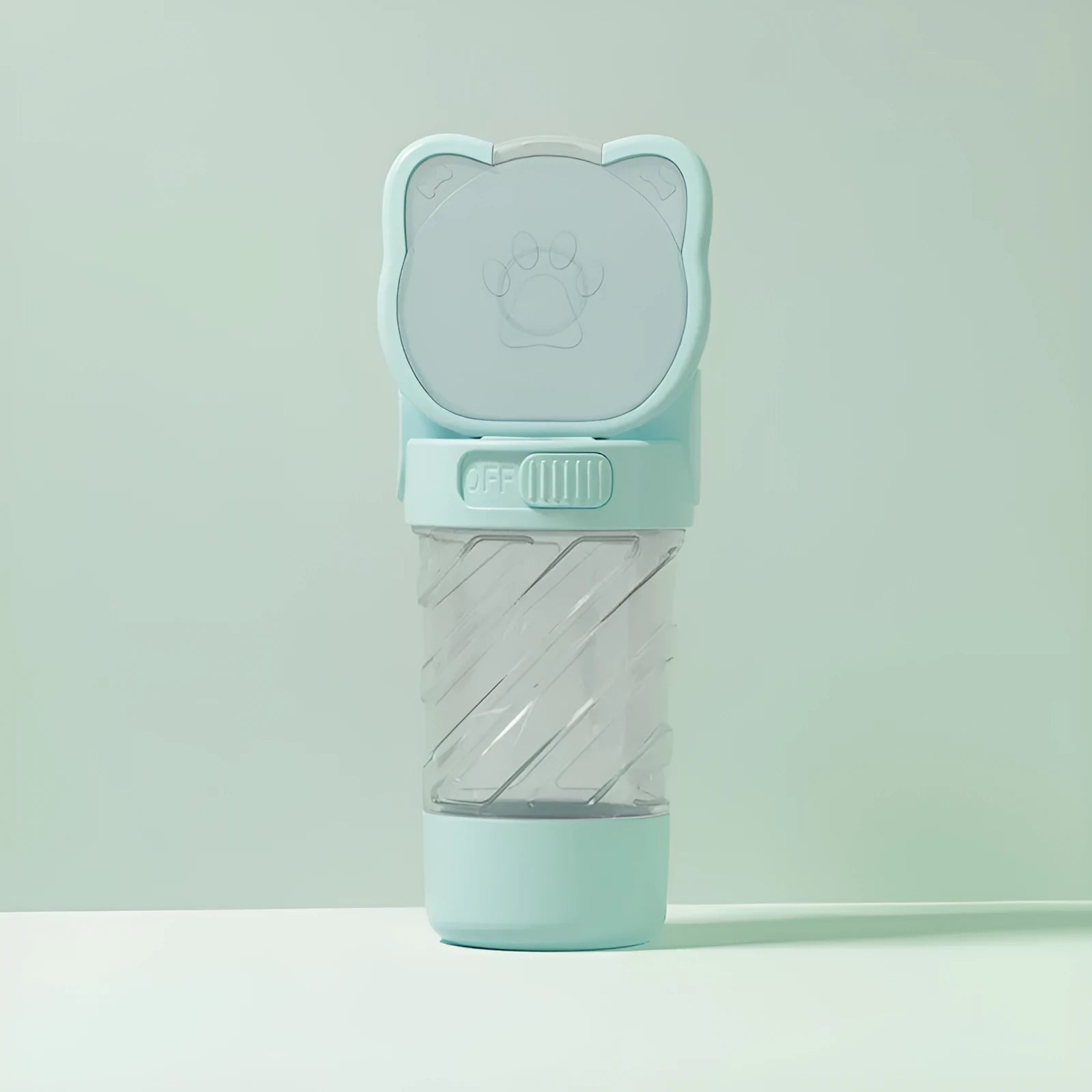 Green 3-in-1 portable pet water bottle with food container and bag dispenser, held by its strap.