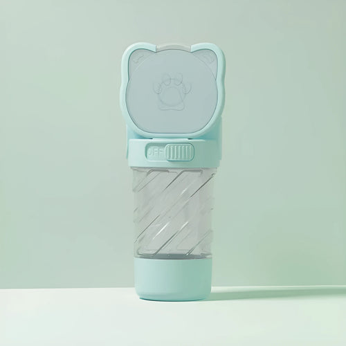 Green 3-in-1 portable pet water bottle with food container and bag dispenser, held by its strap.