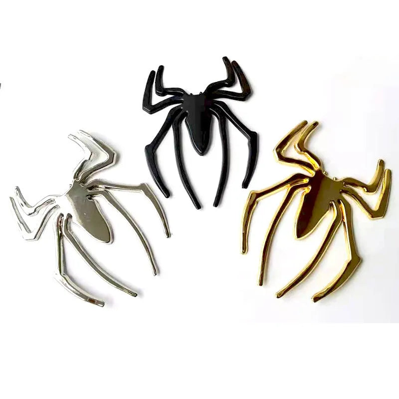 Three-dimensional metal spider bumper sticker in metallic finish measuring 7cm by 5cm