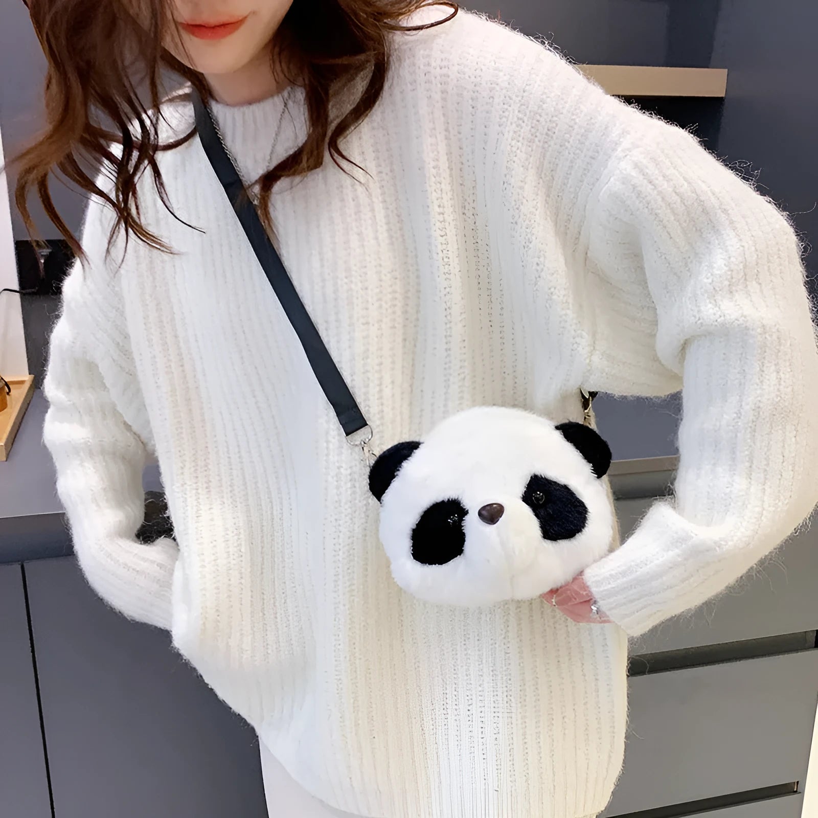 Soft plush panda head crossbody bag with cylindrical shape and outer pocket.
