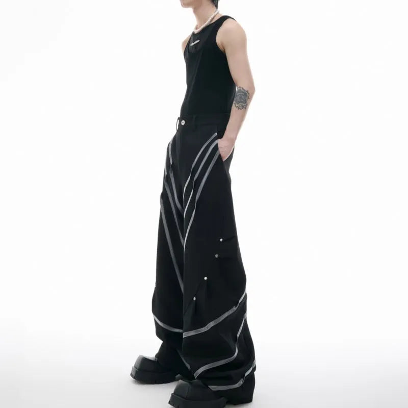 Men's black trousers with metal rivet stripes and pleated detail on the leg.