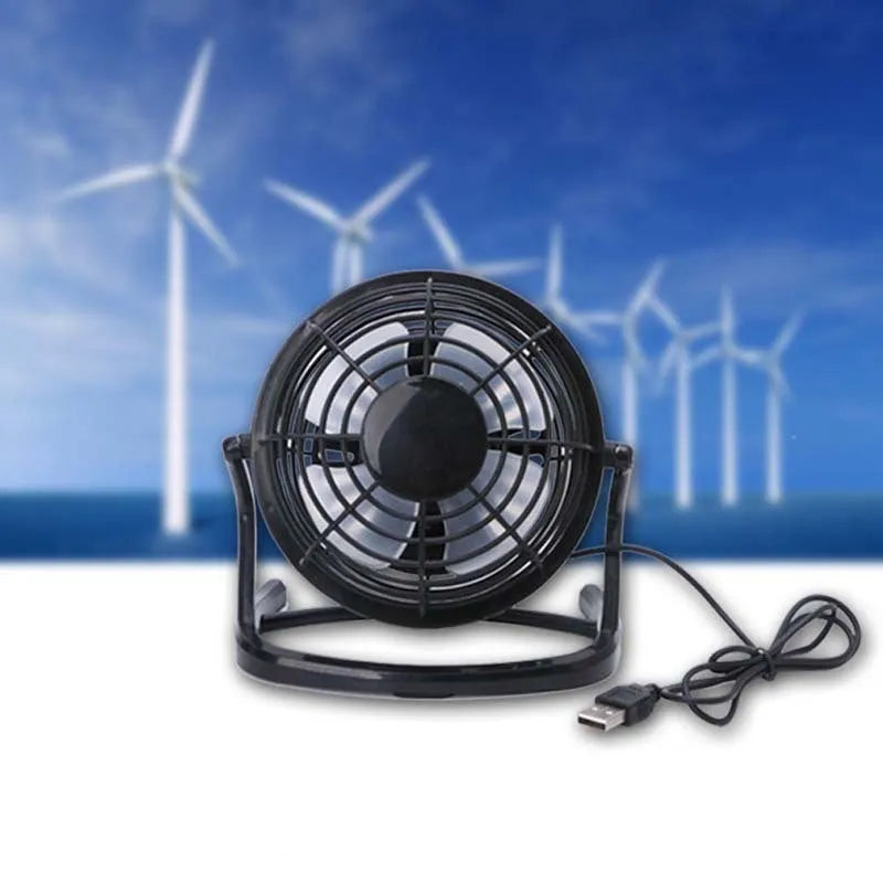 Small black adjustable USB desk fan with key switch on a wooden table.