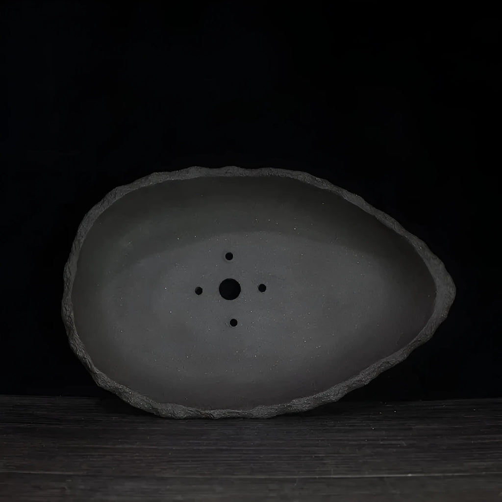Handmade purple clay flower pot with unique shape for floor-standing plant display