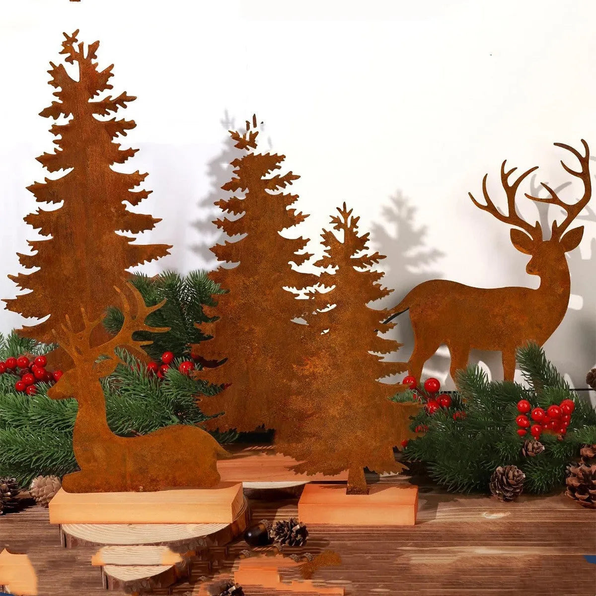 Set of three rusty metal Christmas ornaments featuring elk with antlers and trees, on a white background