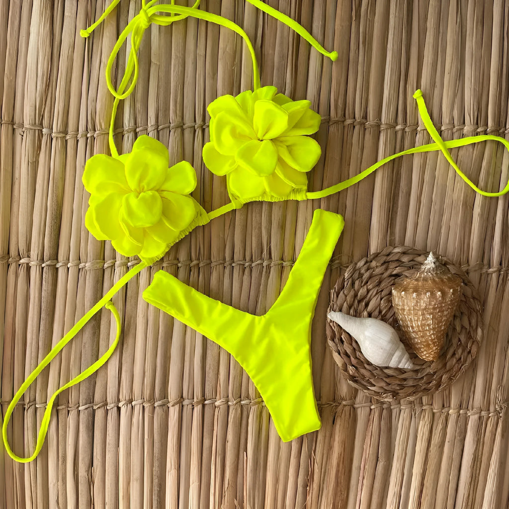 Low waist bikini swimsuit with 3D flower design in solid colour.