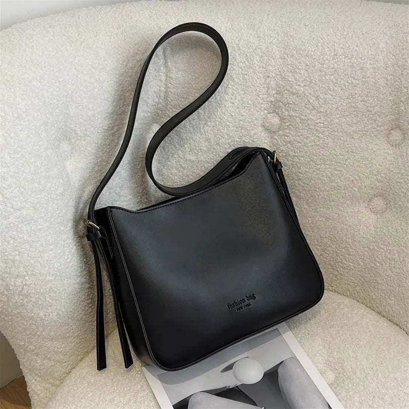 PU shoulder messenger bag in horizontal square shape with slit pocket available in black colour