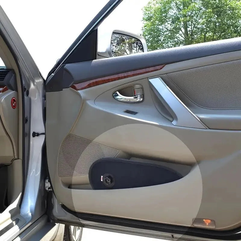 Black breathable car side window sunshade stretched over glass with suction cups.