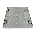 Water resistant dog car seat cover mat on a rear car seat in a bone print pattern.