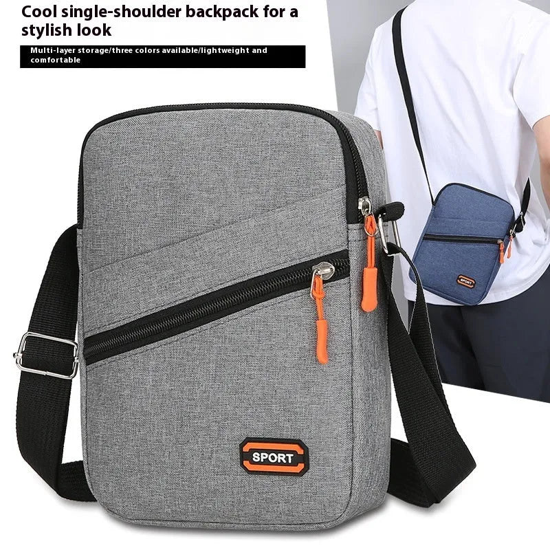 Solid colour Oxford cloth commuter bag with contrast stitching, shown with crossbody strap.
