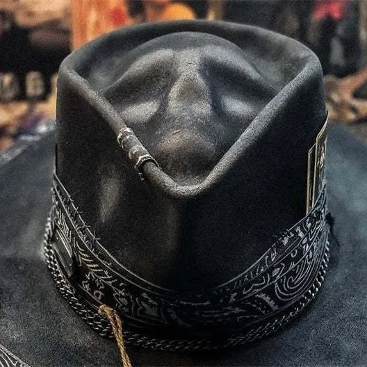 Handmade wool felt skull hat with a pointed conical crown on a neutral background.