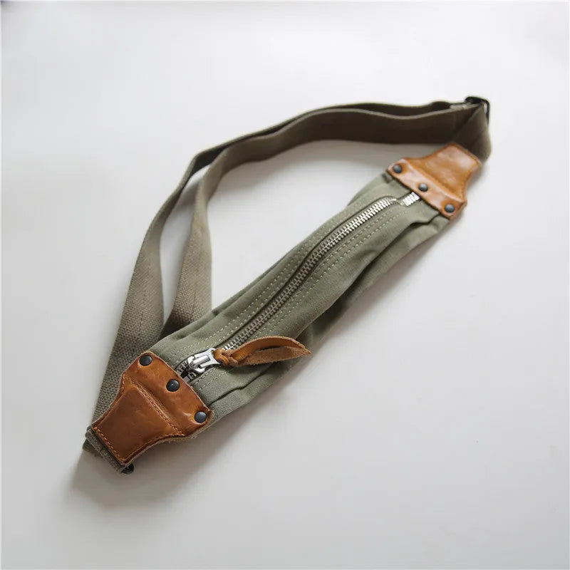 Green retro military style chest bag made of canvas with leather accents.