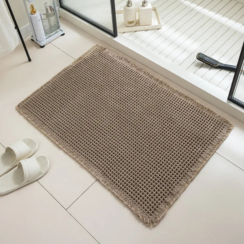Checkered pattern non-slip absorbent bathroom floor carpet in beige colour.