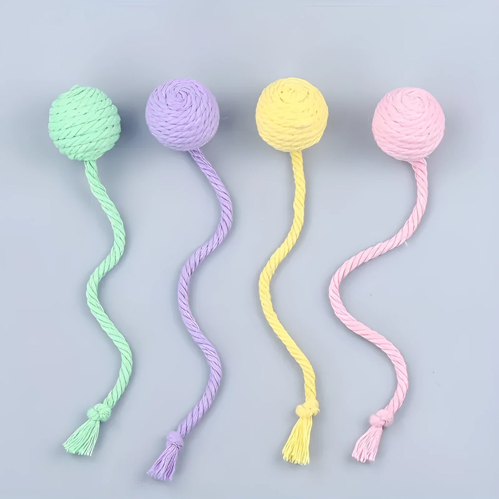 Colourful cat toy ball with attached rope and internal bell, shown in green, pink, purple, and yellow variants.