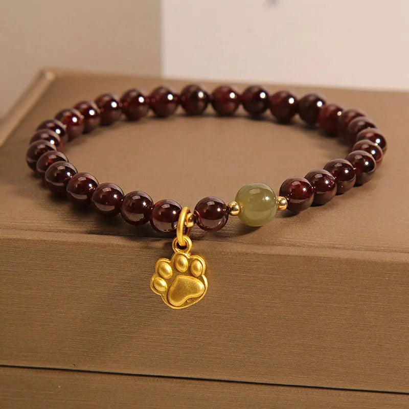 Women's Cat's Paw garnet style crystal bracelet on packaging