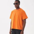 Pure cotton American-style loose fit T-shirt shown in apricot colour on a hanger.