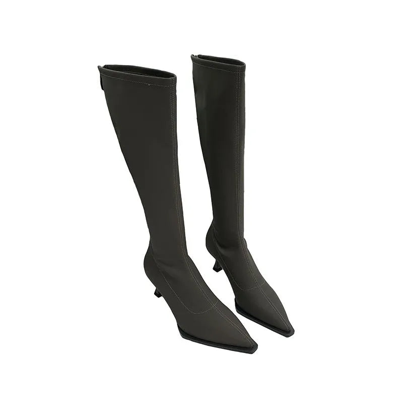 Women's black pointed toe below knee stiletto heel boots with a back zipper on display.