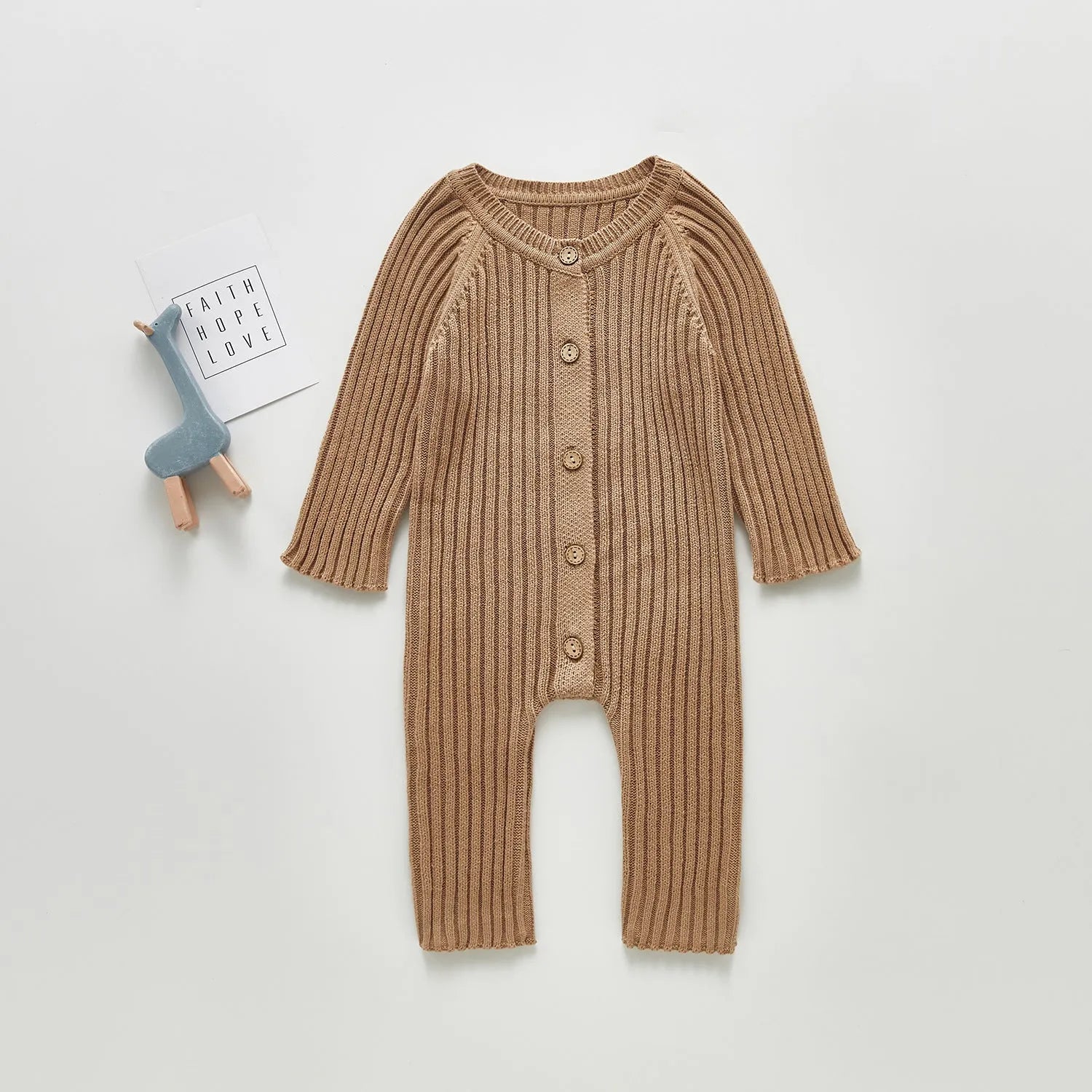 Baby long-sleeved knitted jumpsuit romper pullover in beige, size 80cm, lying flat on a white background