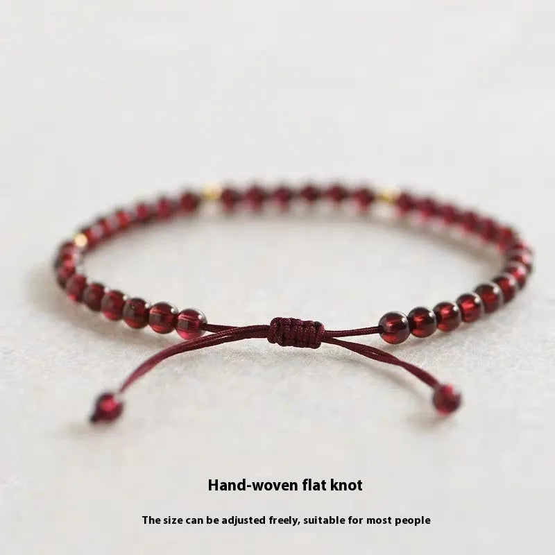 Hand-woven garnet Chinese bracelet with red rope design on flexible wire