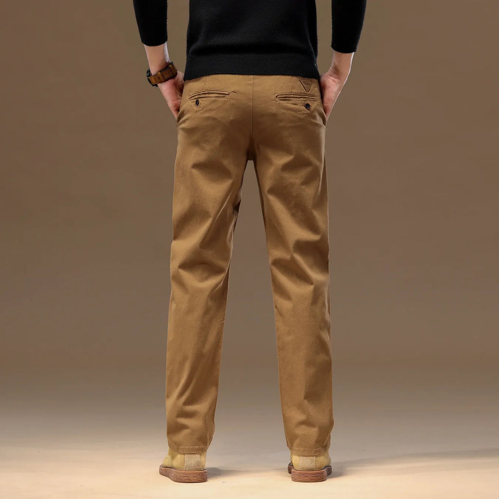 Men's cotton denim loose straight casual trousers in rust red with zip fly and elastic waist, front view