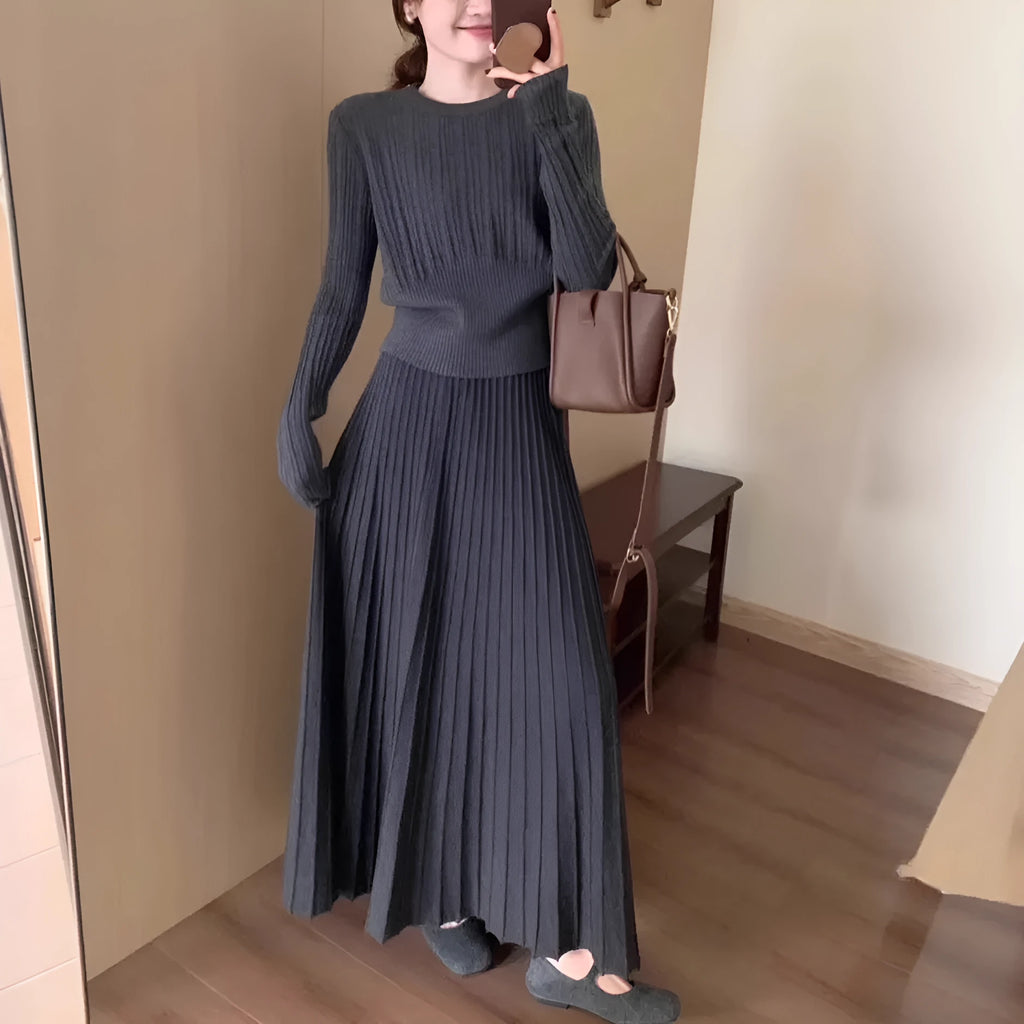 Dark grey knitted two-piece dress suit with 3D pattern, showing sweater and skirt.