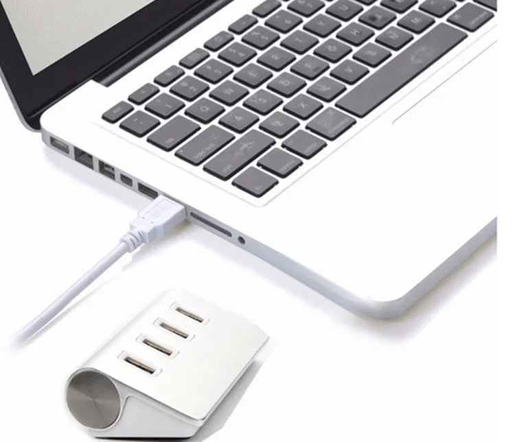 Silver aluminium alloy four-port USB 3.0 hub on a desk with cables connected, 98x58x30mm