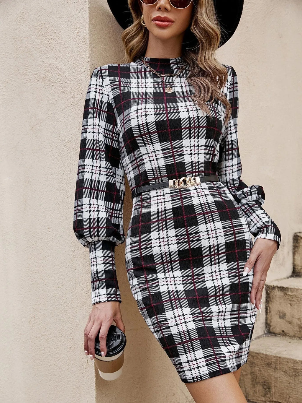 Black tight-fitting midi dress with lantern sleeves and leather stitch detailing.