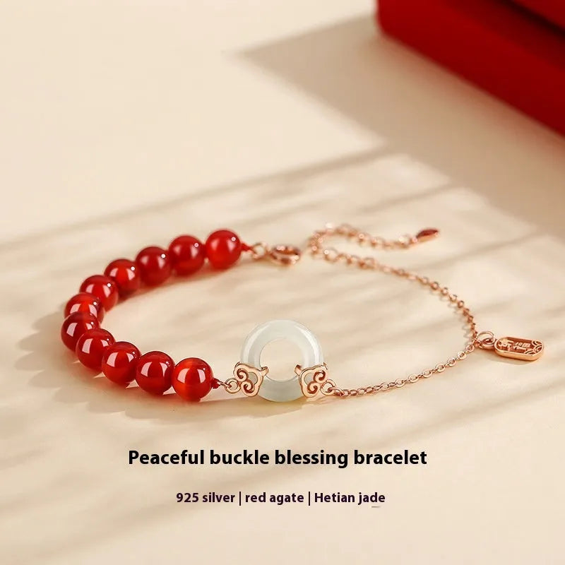 Close-up of a women's sterling silver bracelet with a peace buckle, xiangyun cloud patterns, and a Fu character.