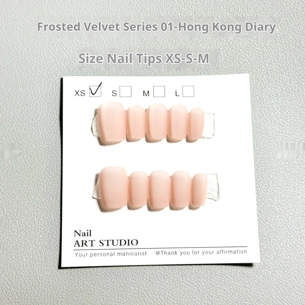 Set of false nails with frosted velvet finish and Cat's Eye designs in short ladder sizes XS, S, and M.