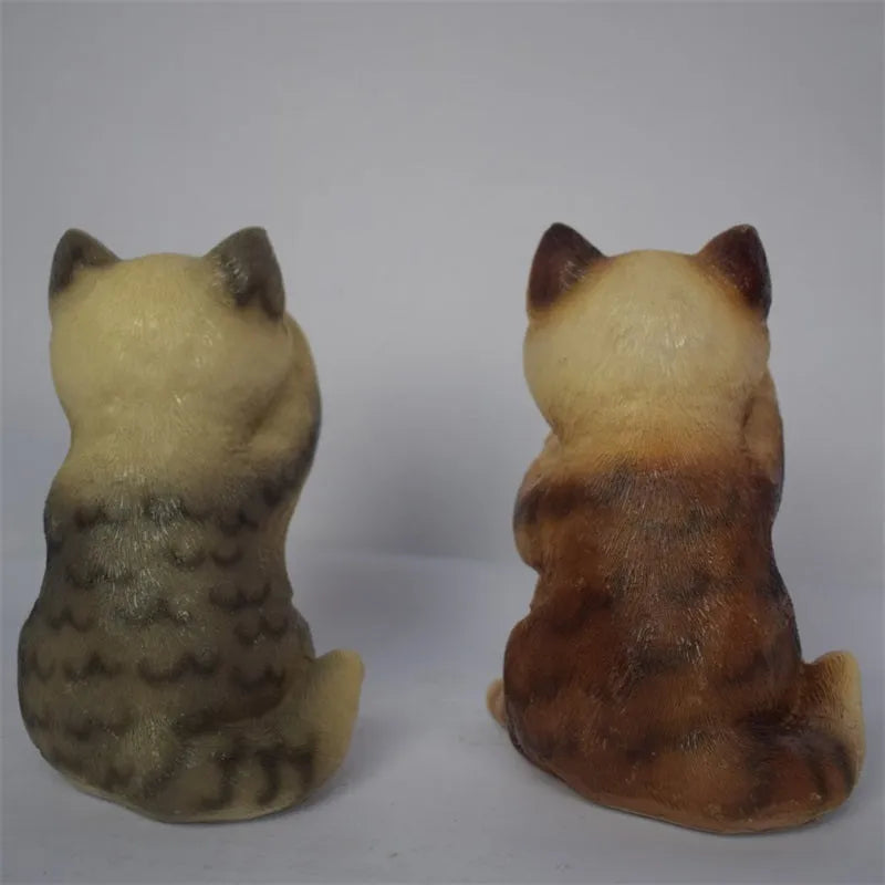 Brown cat-shaped resin solar light standing in a garden