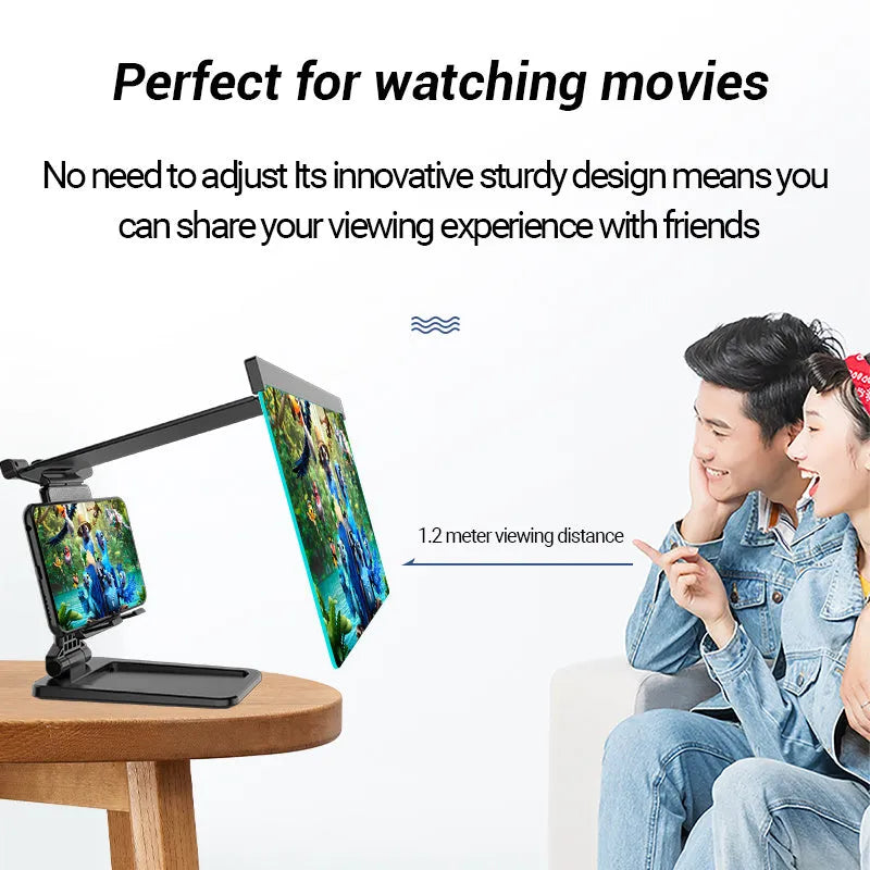 Black folding mobile phone screen amplifier with detached phone holder on a desk