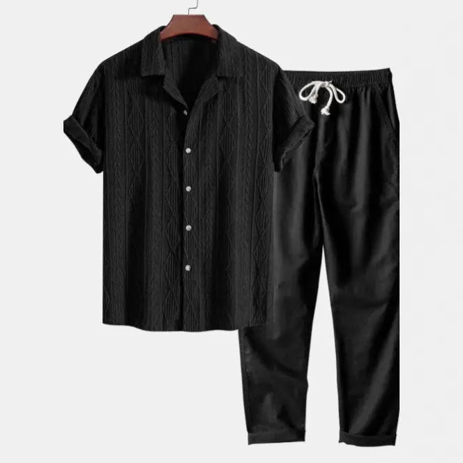 Casual linen suit set with camouflage print, featuring a short-sleeved top and matching trousers.