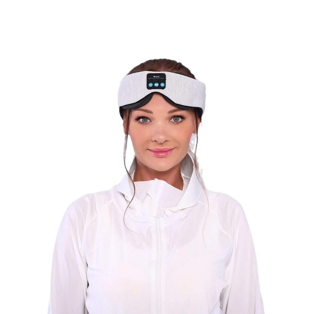 Grey outline Bluetooth sleeping eye mask with adjustable head strap on neutral background