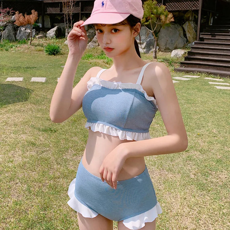 Women's conservative one-piece swimsuit with split design and suspender straps in solid colour