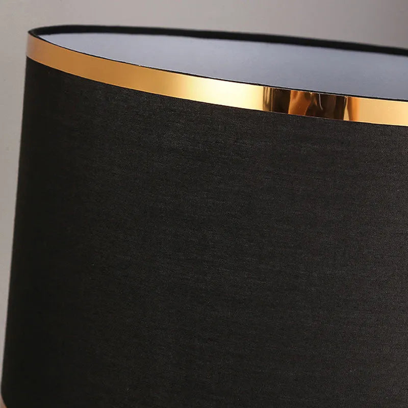 Desk lamp with iron base and fabric shade in choice of black, gold or white colours