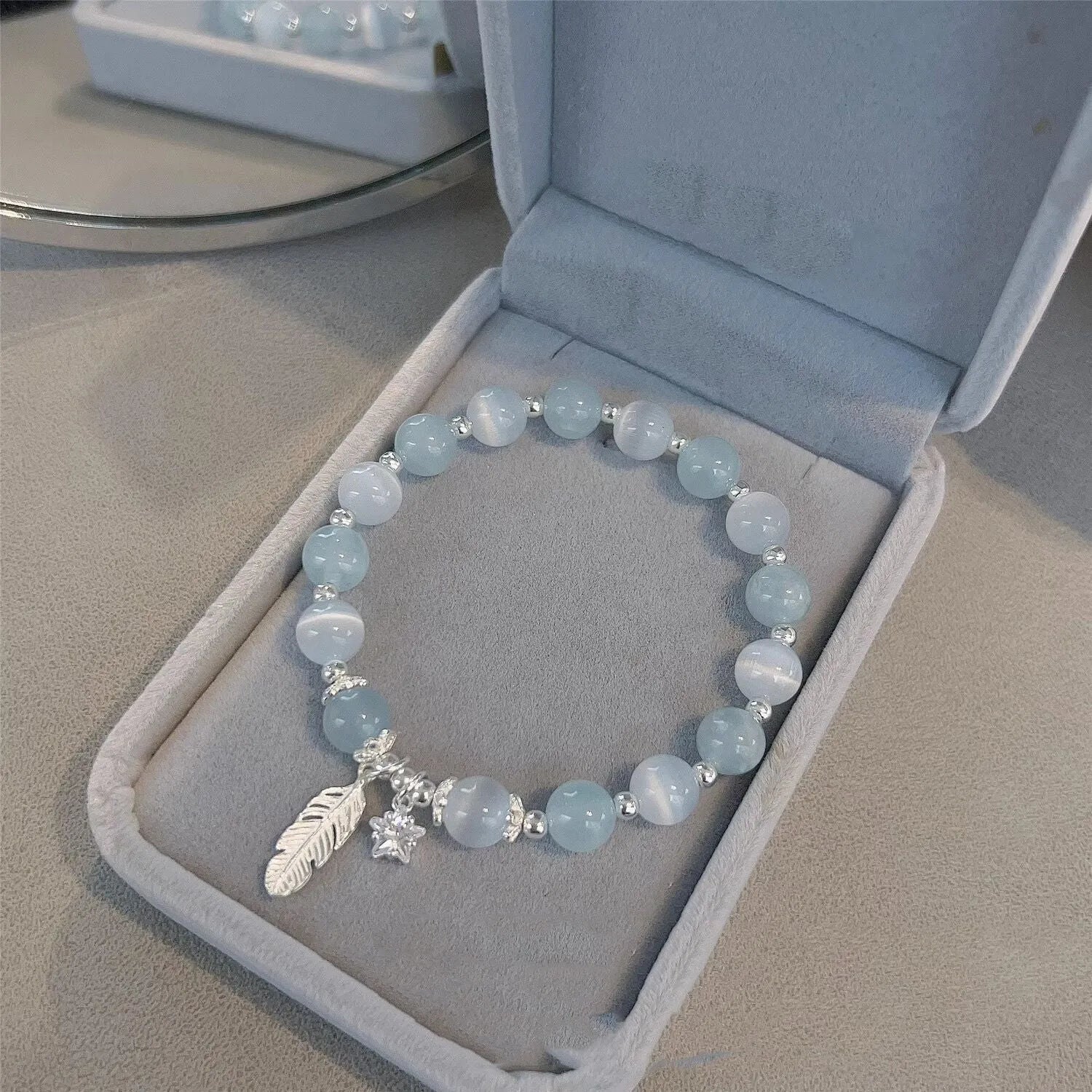Glass crystal bead bracelet with blue moonlight colour and eight star design elements