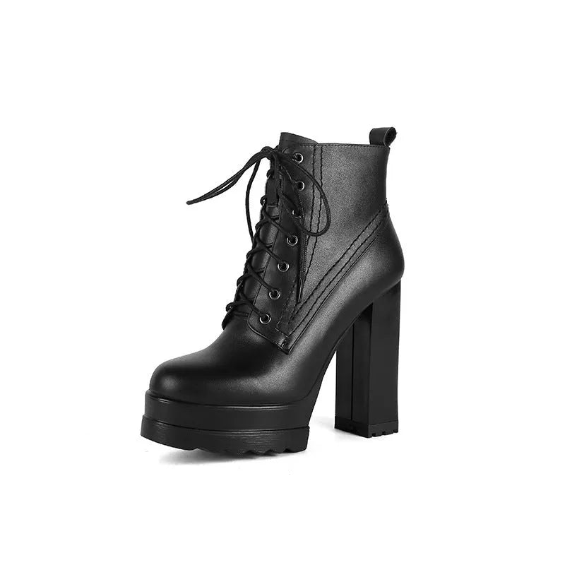 Women's black waterproof platform boots with a chunky heel and side zip fastening on a white background.